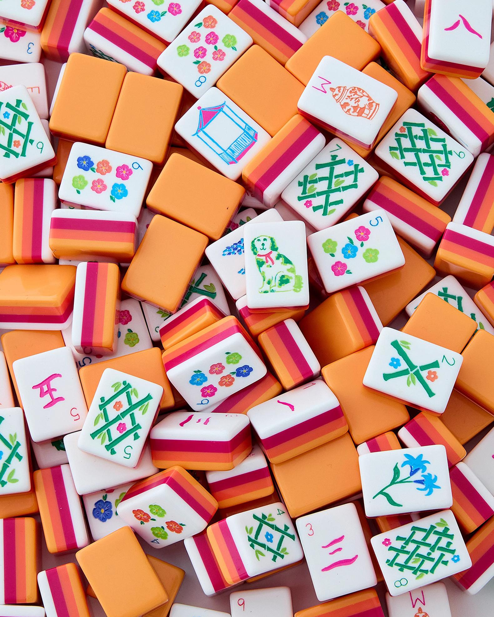 A Mahjong Tiles Set on a Table with a Notebook - Representing the Pieces of the Puzzle When You're Trying to Get Finances Back on Track.