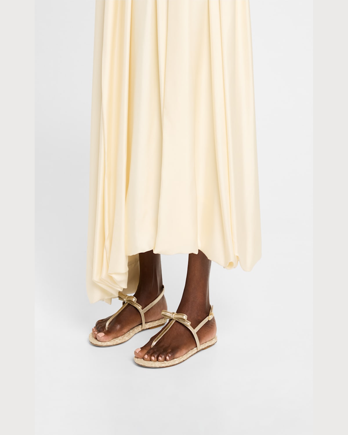 Shop Stuart Weitzman Felicity Metallic Bow T-strap Sandals In Light Goldnatural