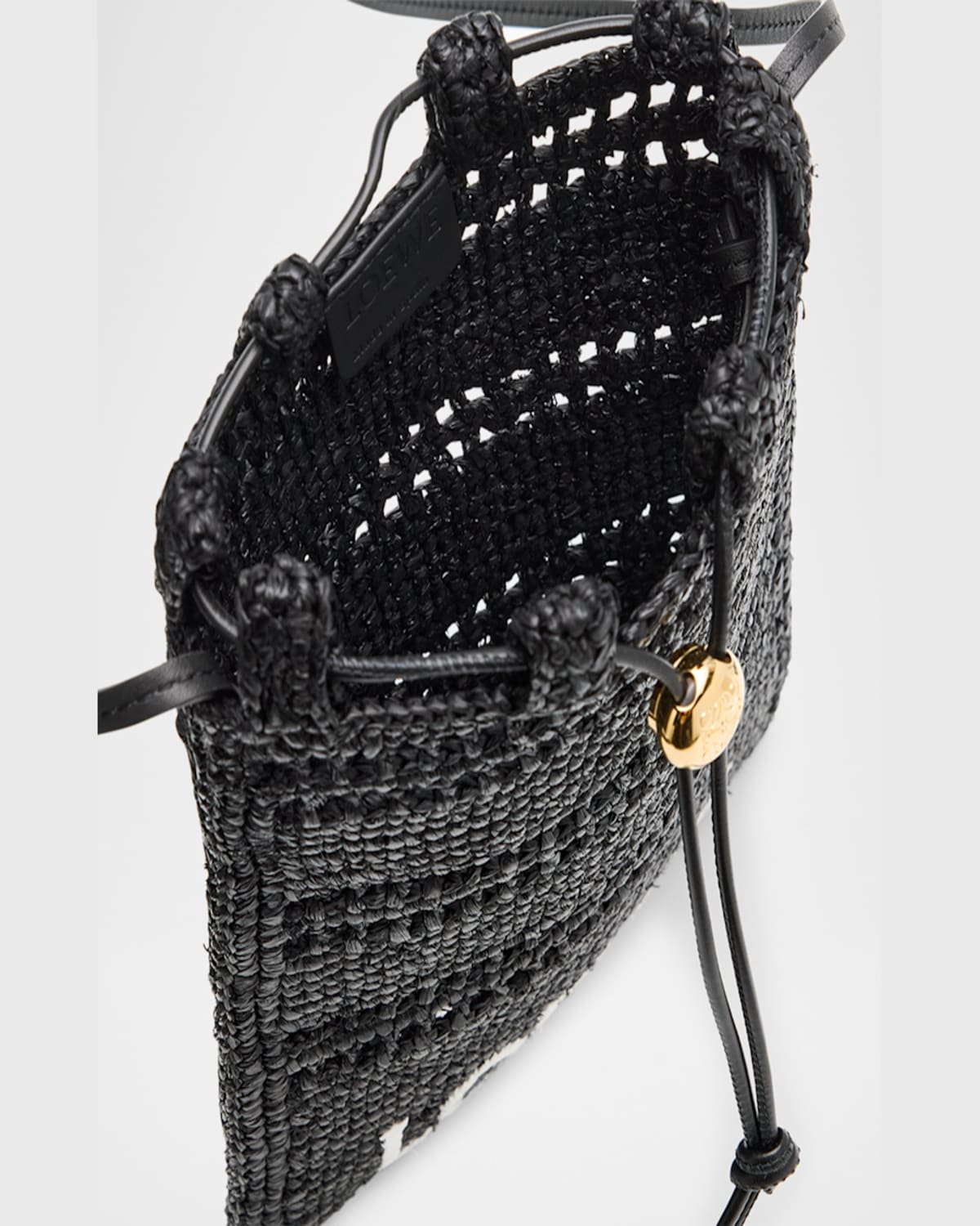 Loewe Drawstring Pocket Crossbody Bag In Raffia In Black