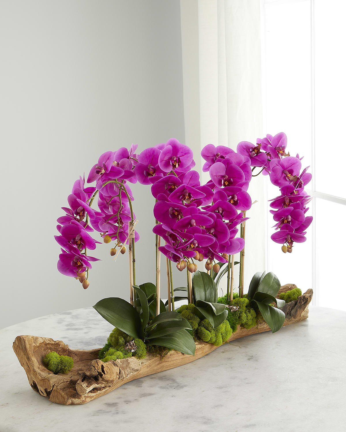 T & C Floral Company Log Filled With Faux Fuchsia Orchids