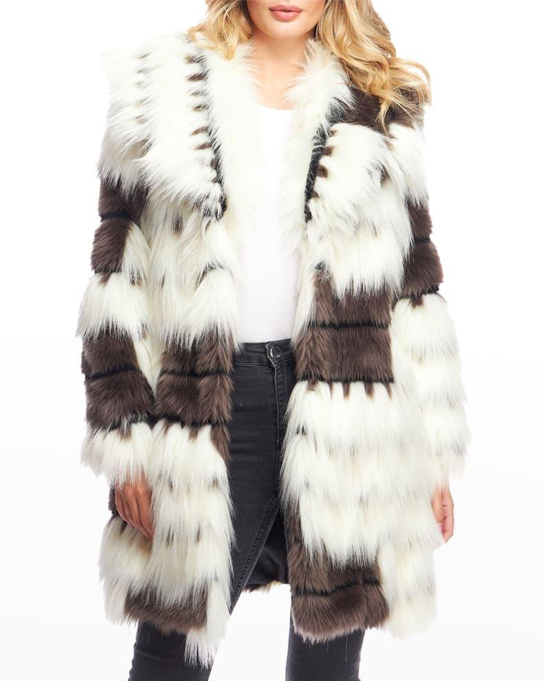 Model dressed in a white and brown Alter Ego faux fur coat, combined with black jeans and a white shirt