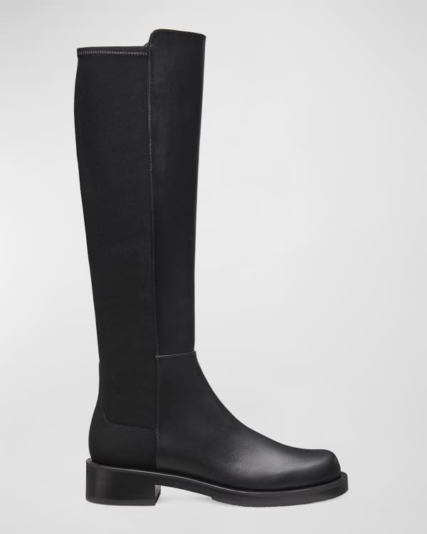 black trousers wearing black leather knee length riding boots - Playground