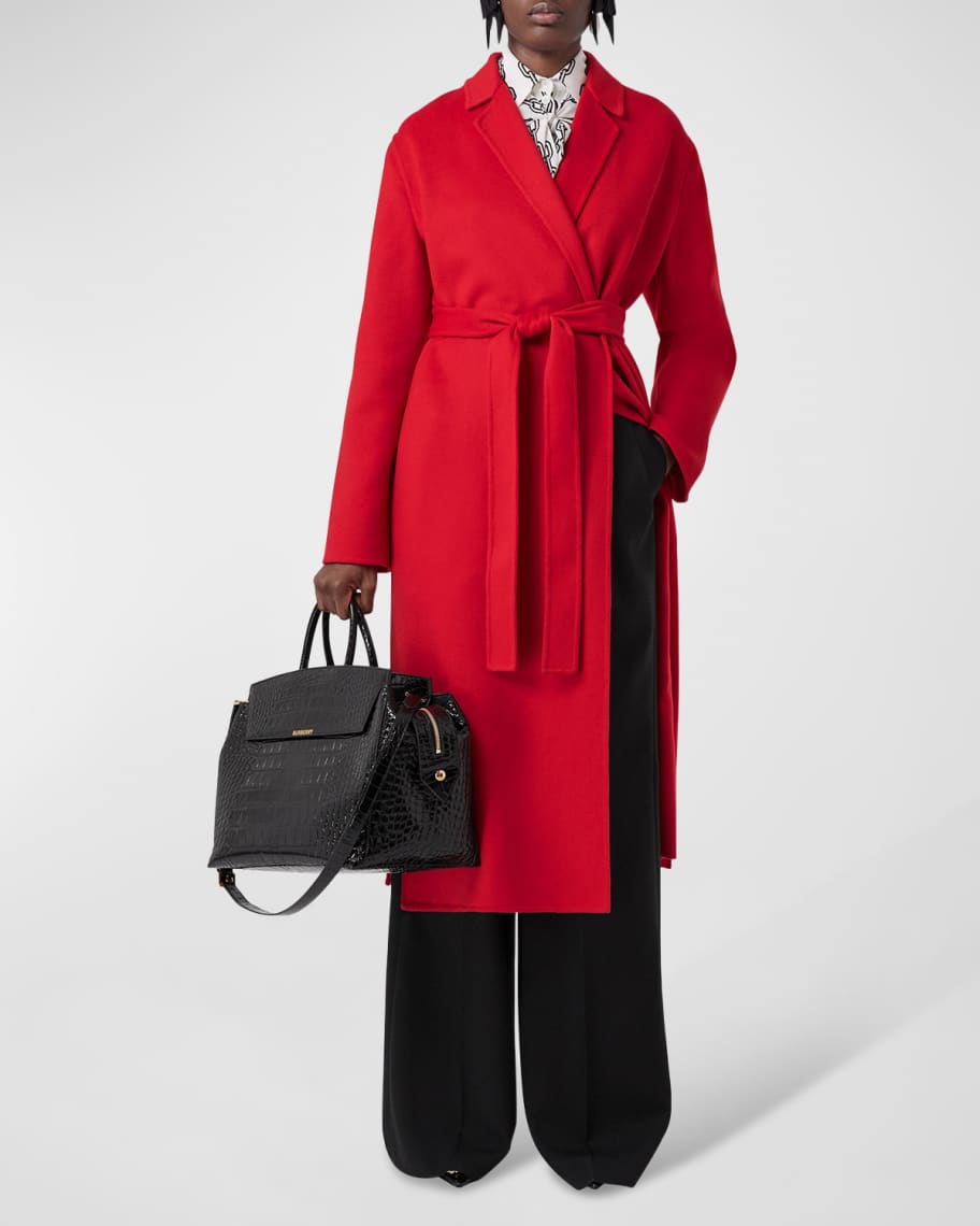 Woolly hat, belted knee length coat, Louis Vuitton briefcase and