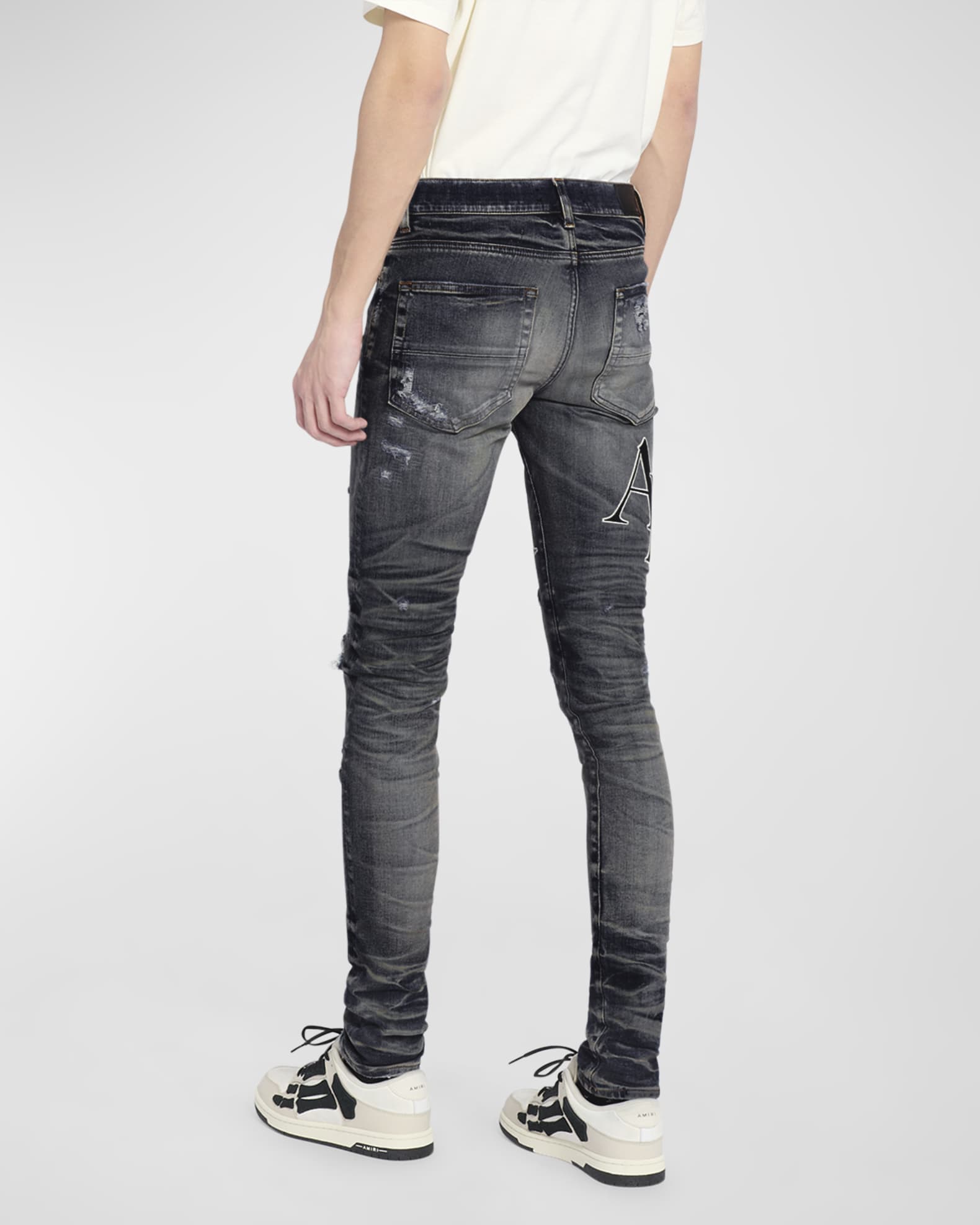 Amiri Men's Staggered Logo Skinny Jeans | Neiman Marcus