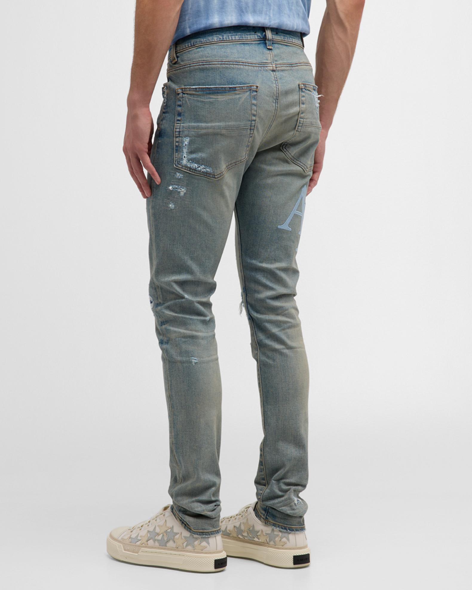 Amiri Men's Staggered Logo Skinny Jeans | Neiman Marcus